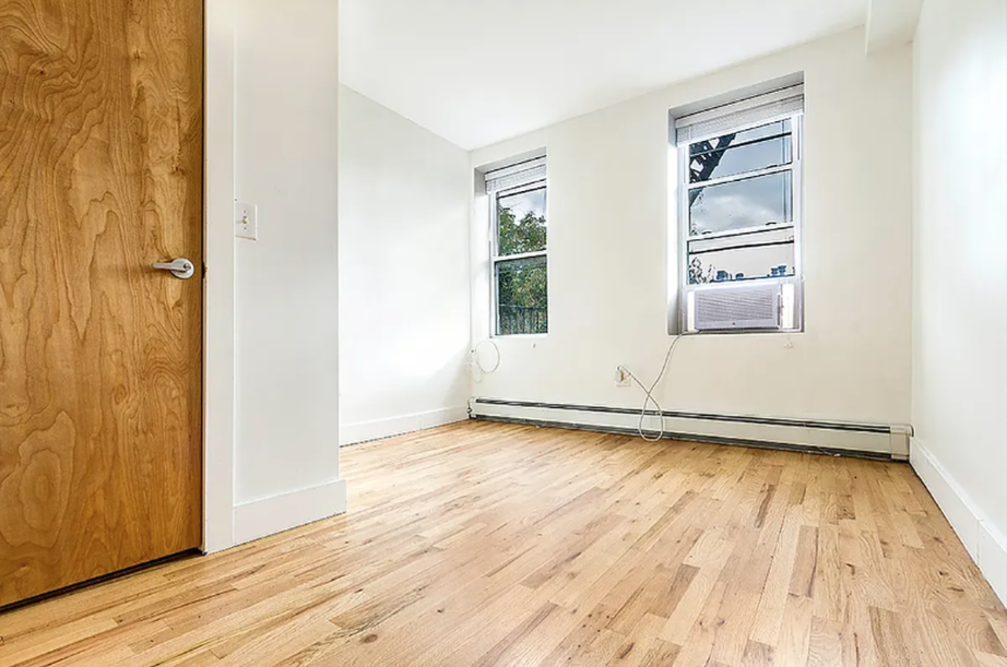 406 Monroe Street, Unit 3 Brooklyn, NY 11221 - Photo 4 of 11 a view of an empty room with wooden floor and a window