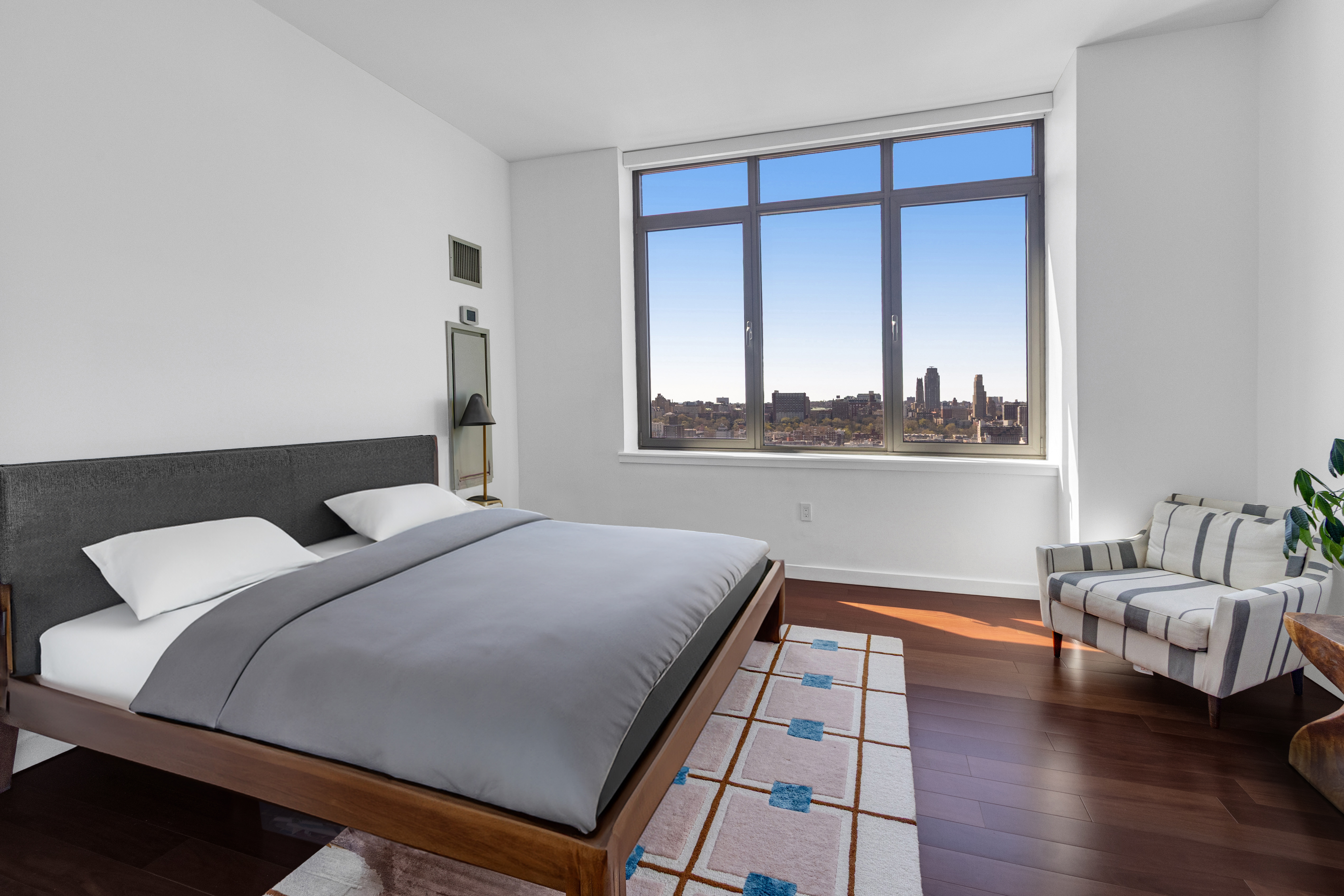 1485 5th Avenue, Unit 24F Manhattan, NY 10035 - Photo 4 of 16 a bedroom with a bed and window