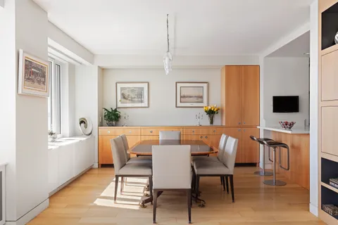 a view of a dining room with furniture and a window