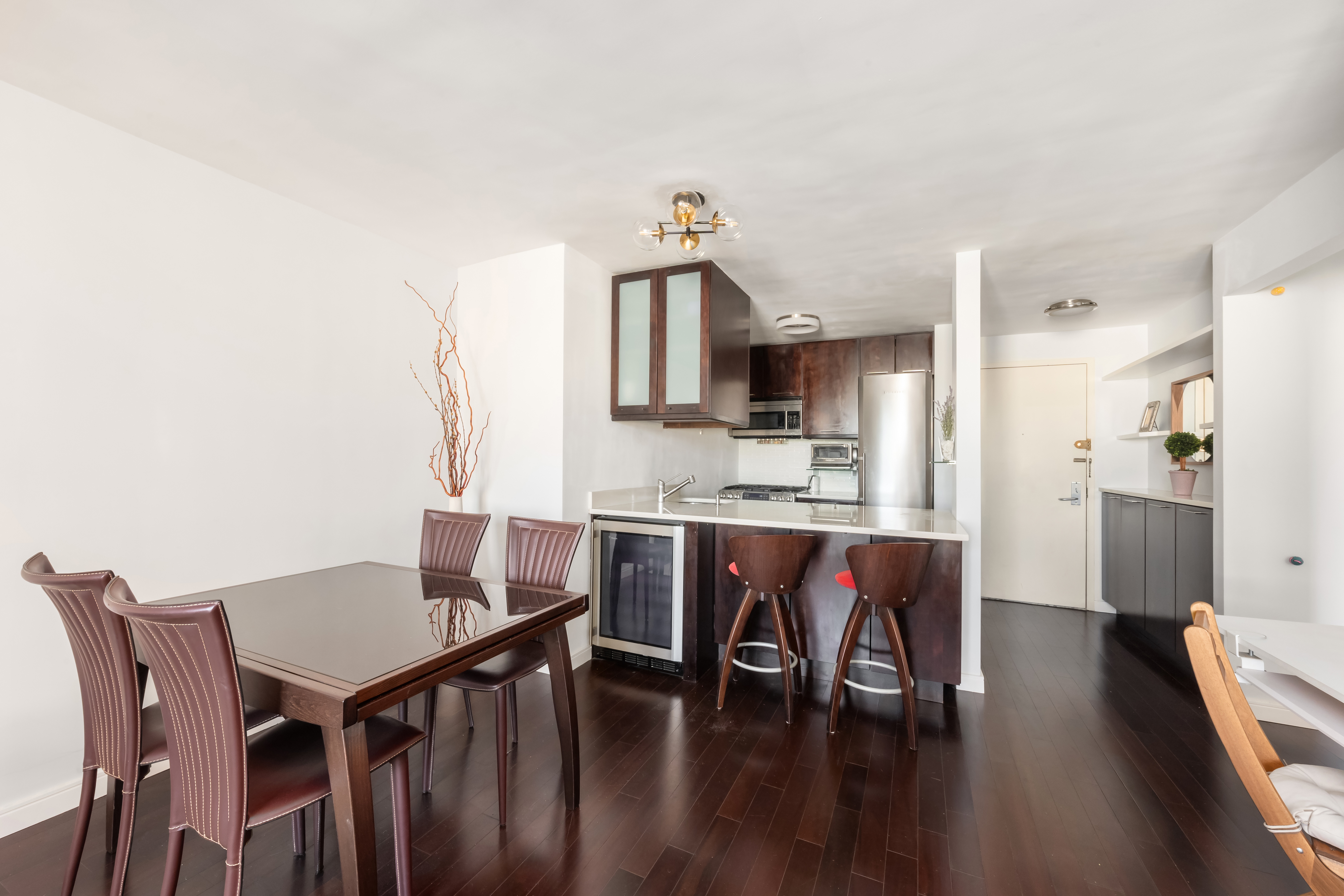 376 Broadway, Unit 14E Manhattan, NY 10013 - Photo 3 of 11 a view of a dining room with furniture and wooden floor
