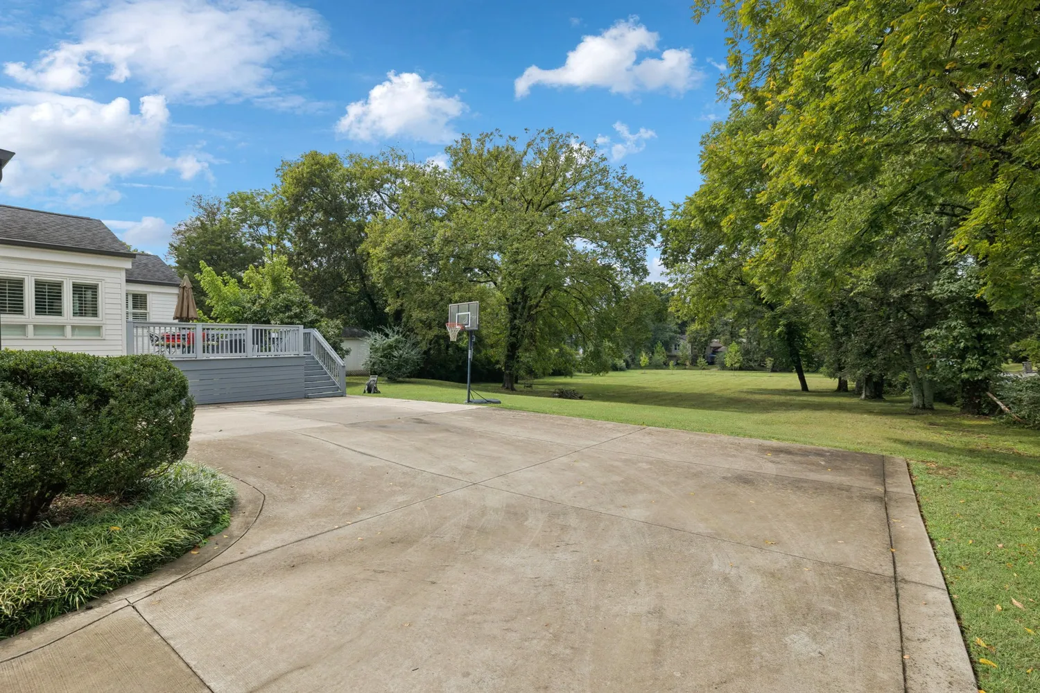 a patio with glass top table and chairs