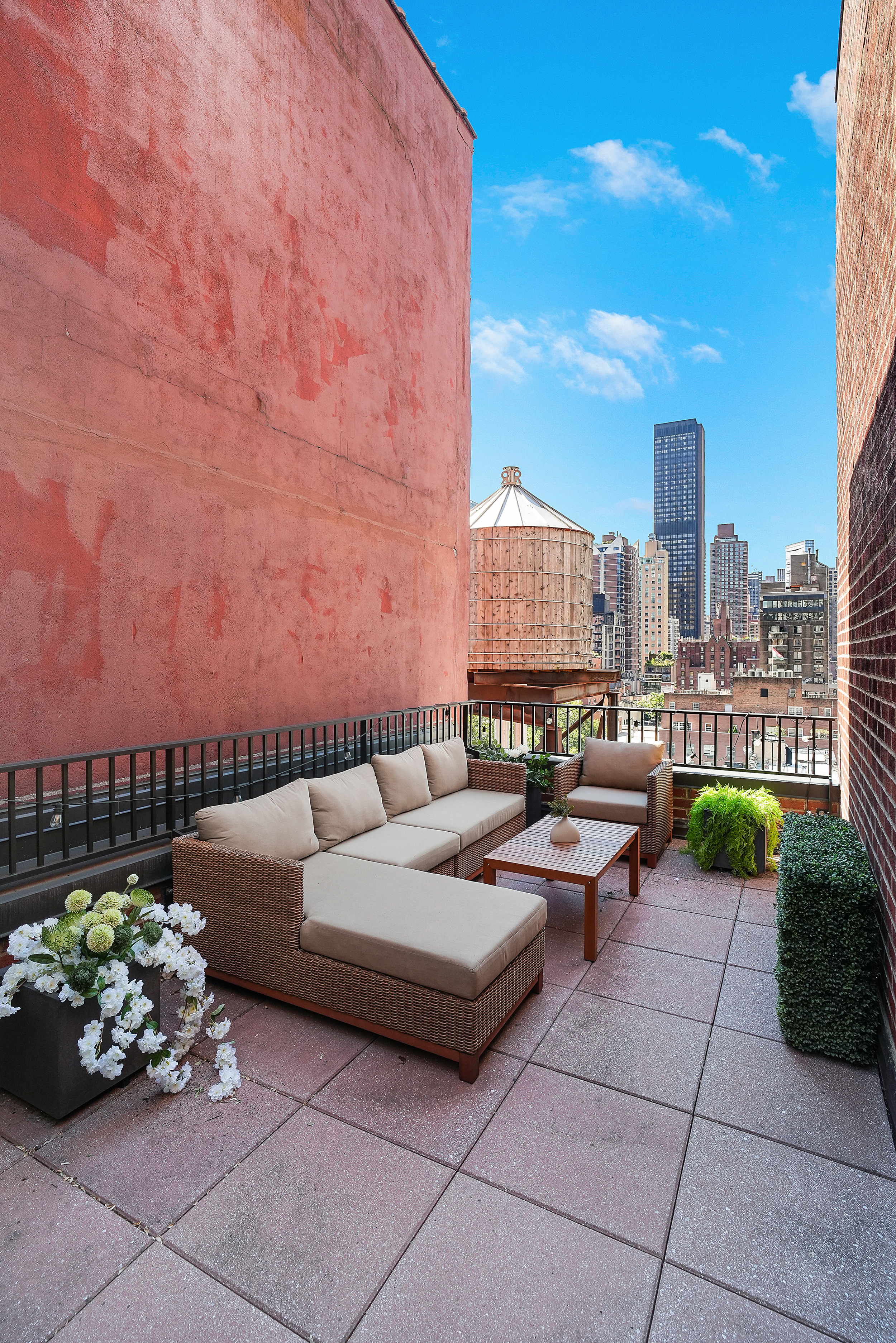 220 East 54th Street, Unit 11H Manhattan, NY 10022 - Photo 9 of 13 a view of a terrace with furniture and a garden