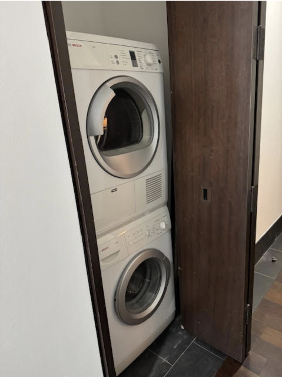 40 Broad Street, Unit 25C Manhattan, NY 10004 - Photo 6 of 10 a utility room with dryer and washer
