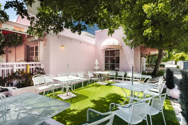 a view of backyard of house with outdoor seating