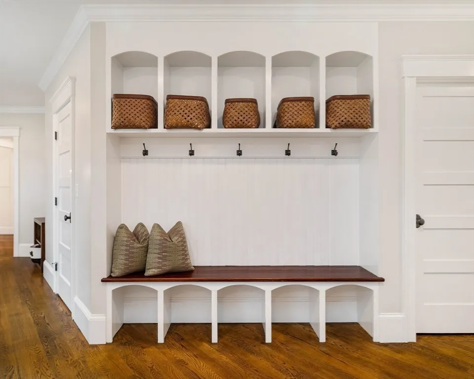 a view of a hallway with cabinet and wooden floor