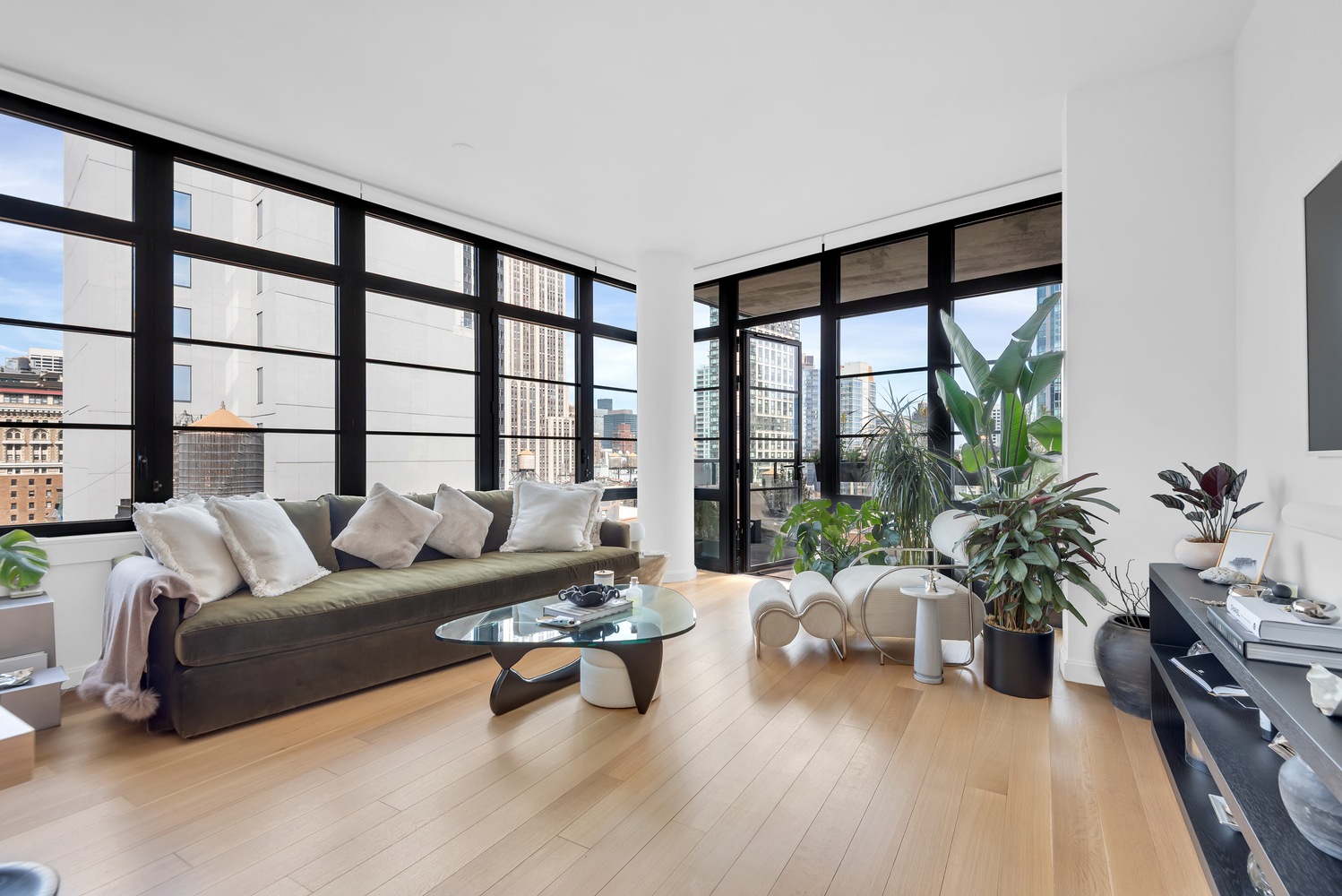 a living room with furniture and a large window with wooden floor