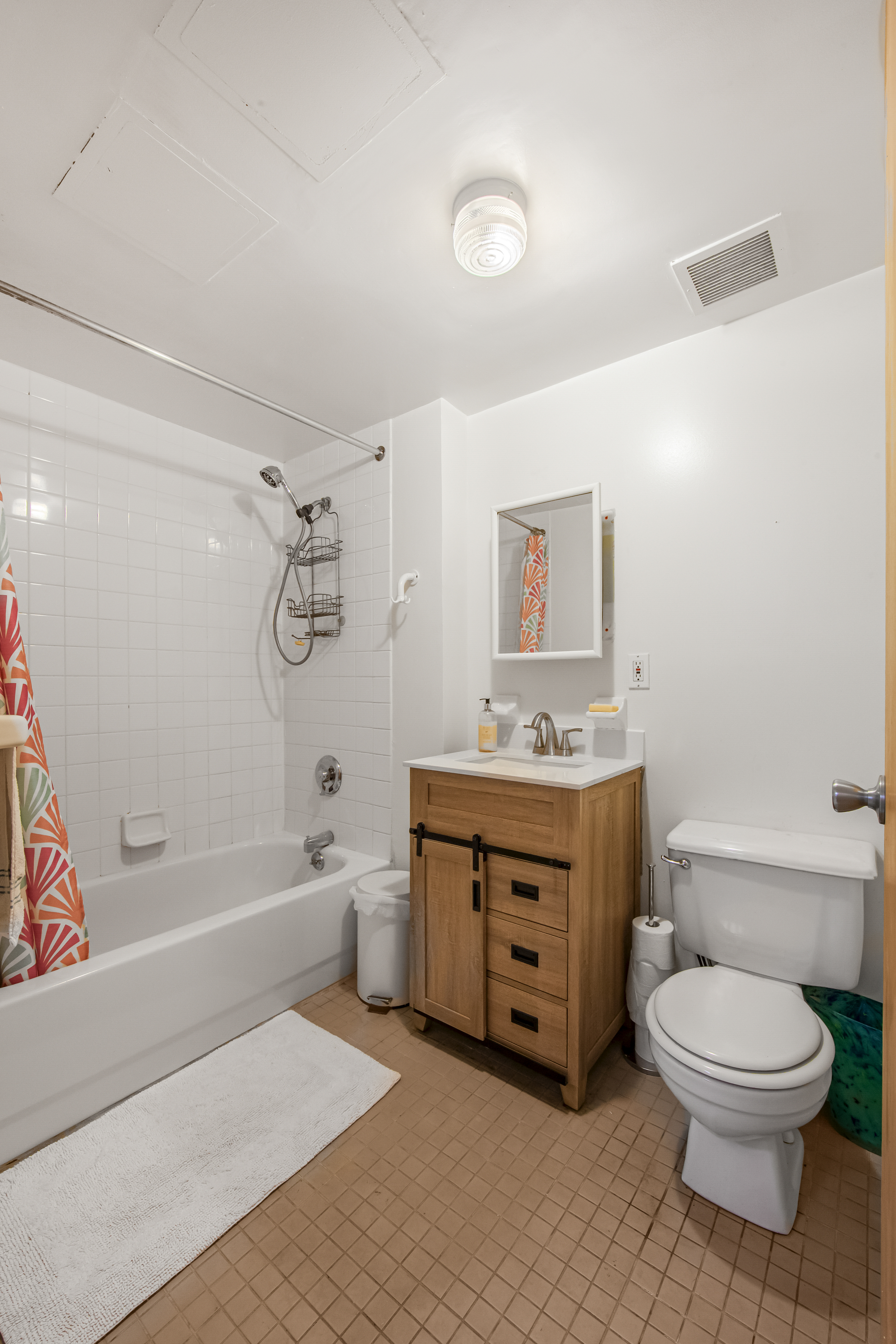 129 Waverly Avenue, Unit 1 Brooklyn, NY 11205 - Photo 10 of 13 a spacious bathroom with a granite countertop toilet a sink and a bathtub