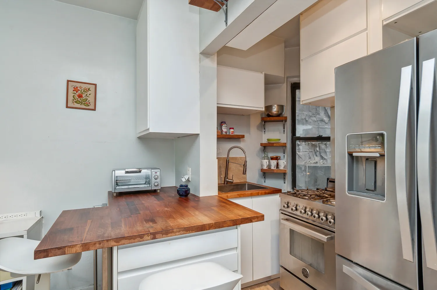 a kitchen with stainless steel appliances granite countertop a refrigerator and a stove
