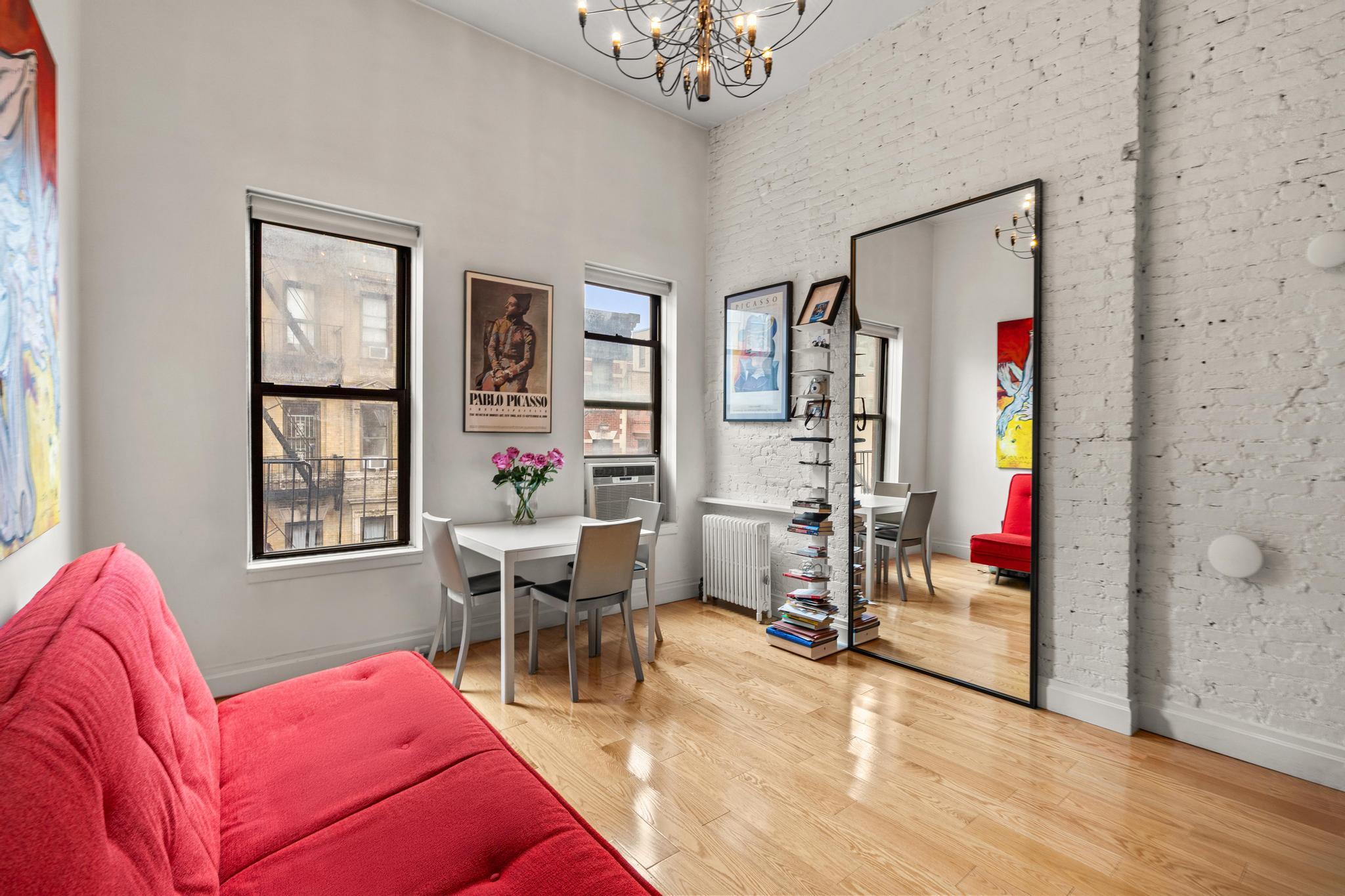 143 Sullivan Street, Unit 16 Manhattan, NY 10012 - Photo 2 of 10 a living room with furniture and a window