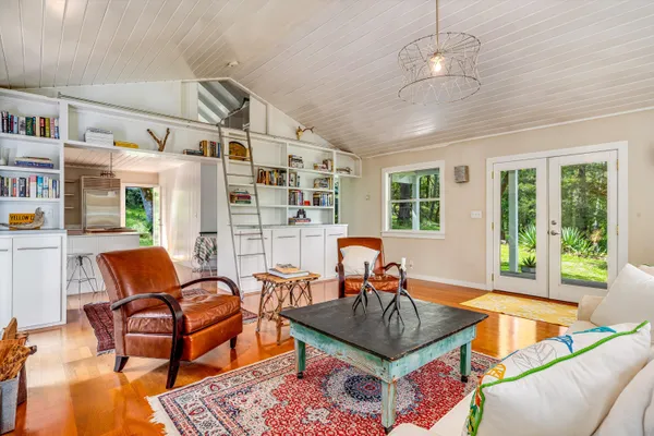 a kitchen with a sink a counter and chairs