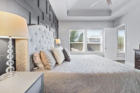 a bedroom with a large bed and a window