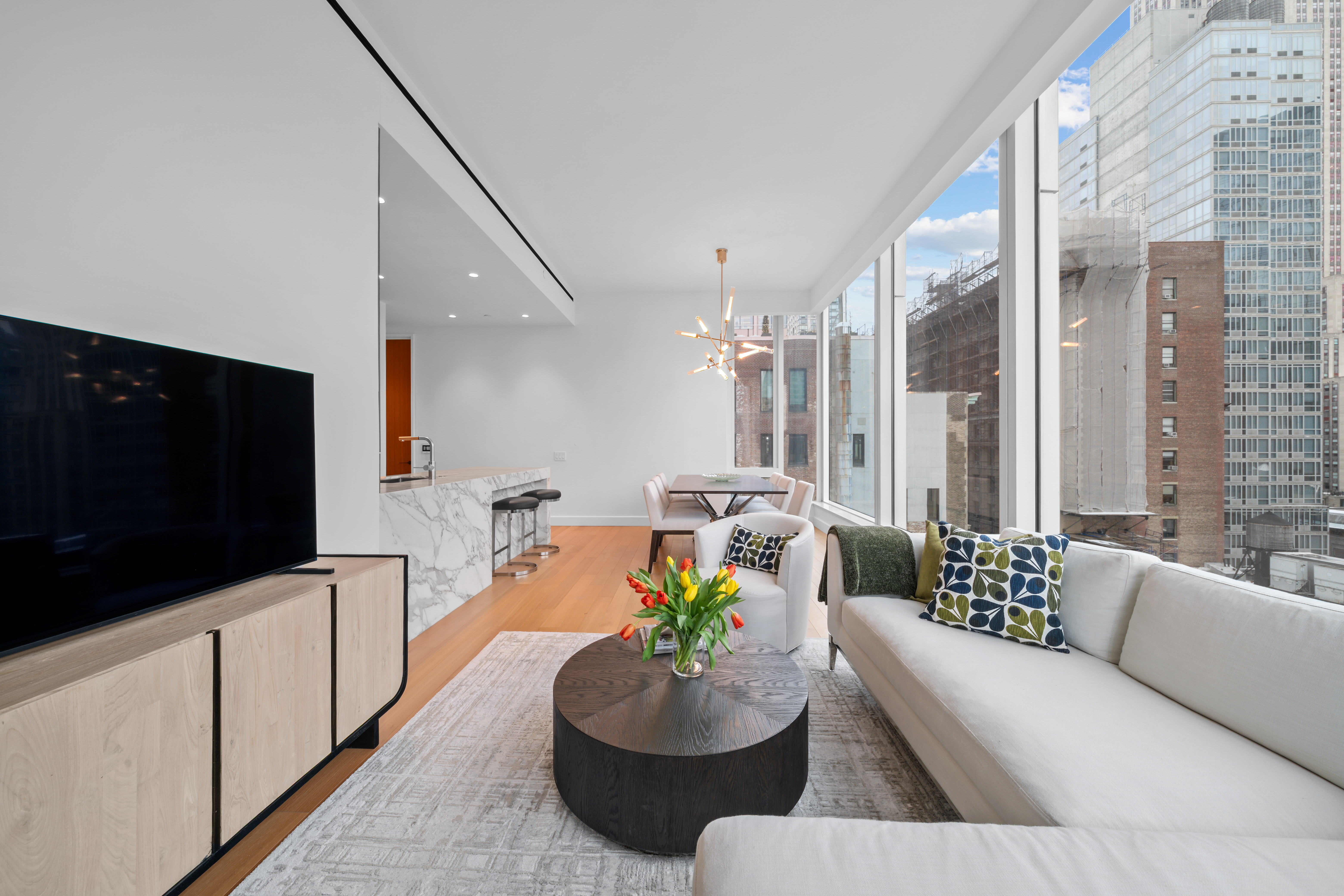 15 East 30th Street, Unit 19B Manhattan, NY 10016 - Photo 8 of 40 a living room with furniture and a flat screen tv