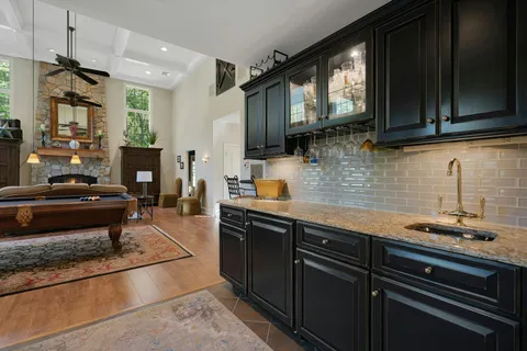 a kitchen with stainless steel appliances granite countertop a sink a stove and a refrigerator