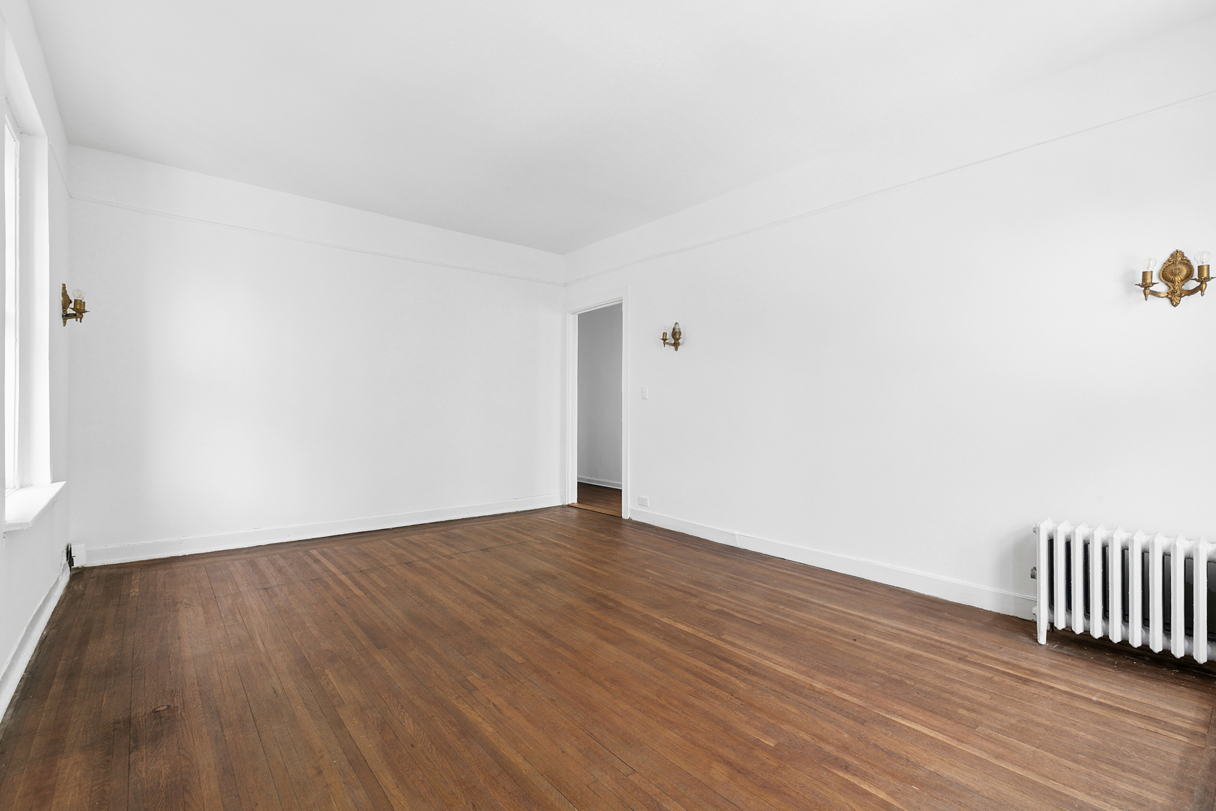 370 Central Park West, Unit 413 Manhattan, NY 10025 - Photo 4 of 19 a view of an empty room with wooden floor