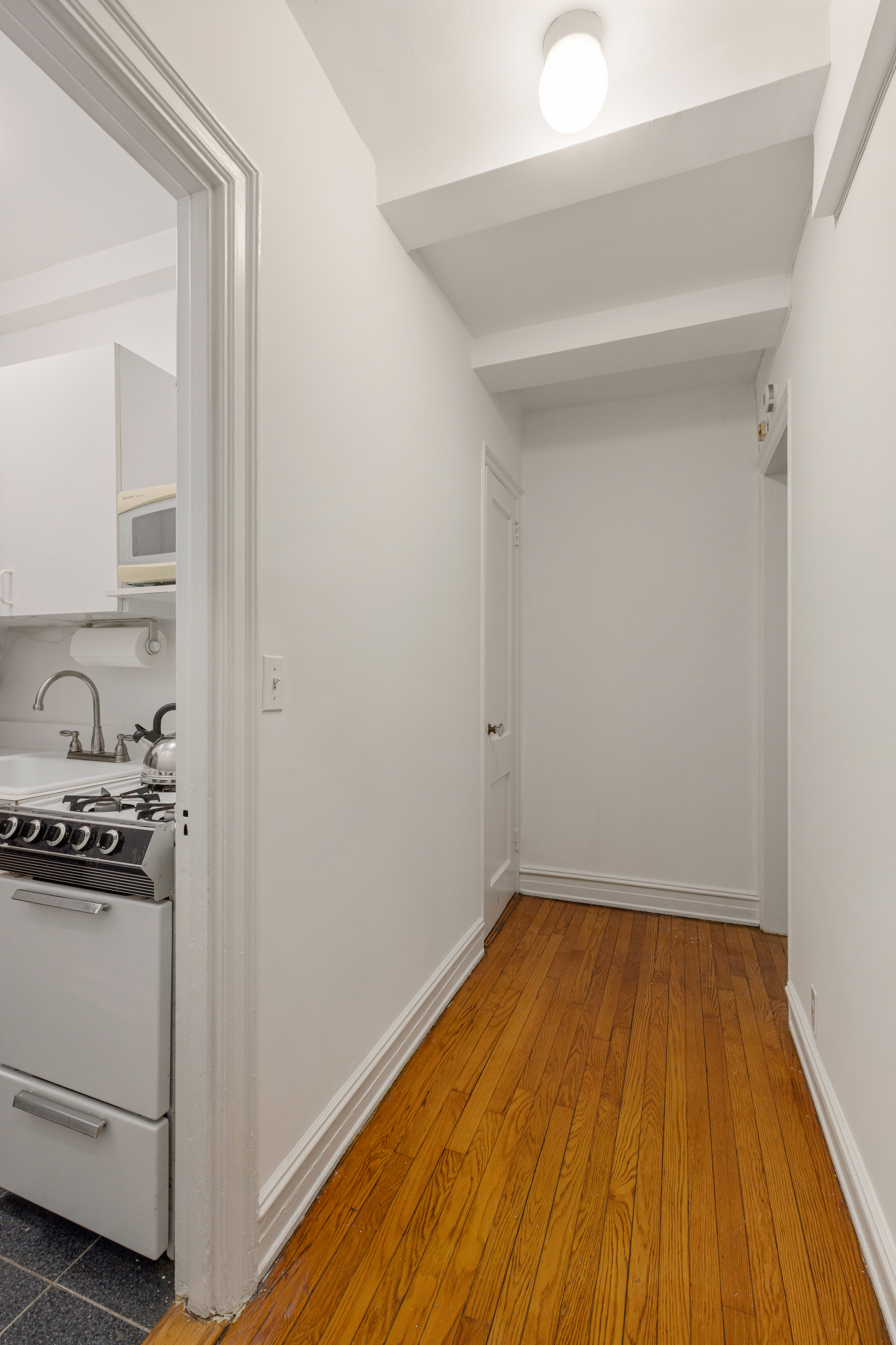 235 West 102nd Street, Unit 4E Manhattan, NY 10025 - Photo 8 of 19 a view of a room with wooden floor and cabinets