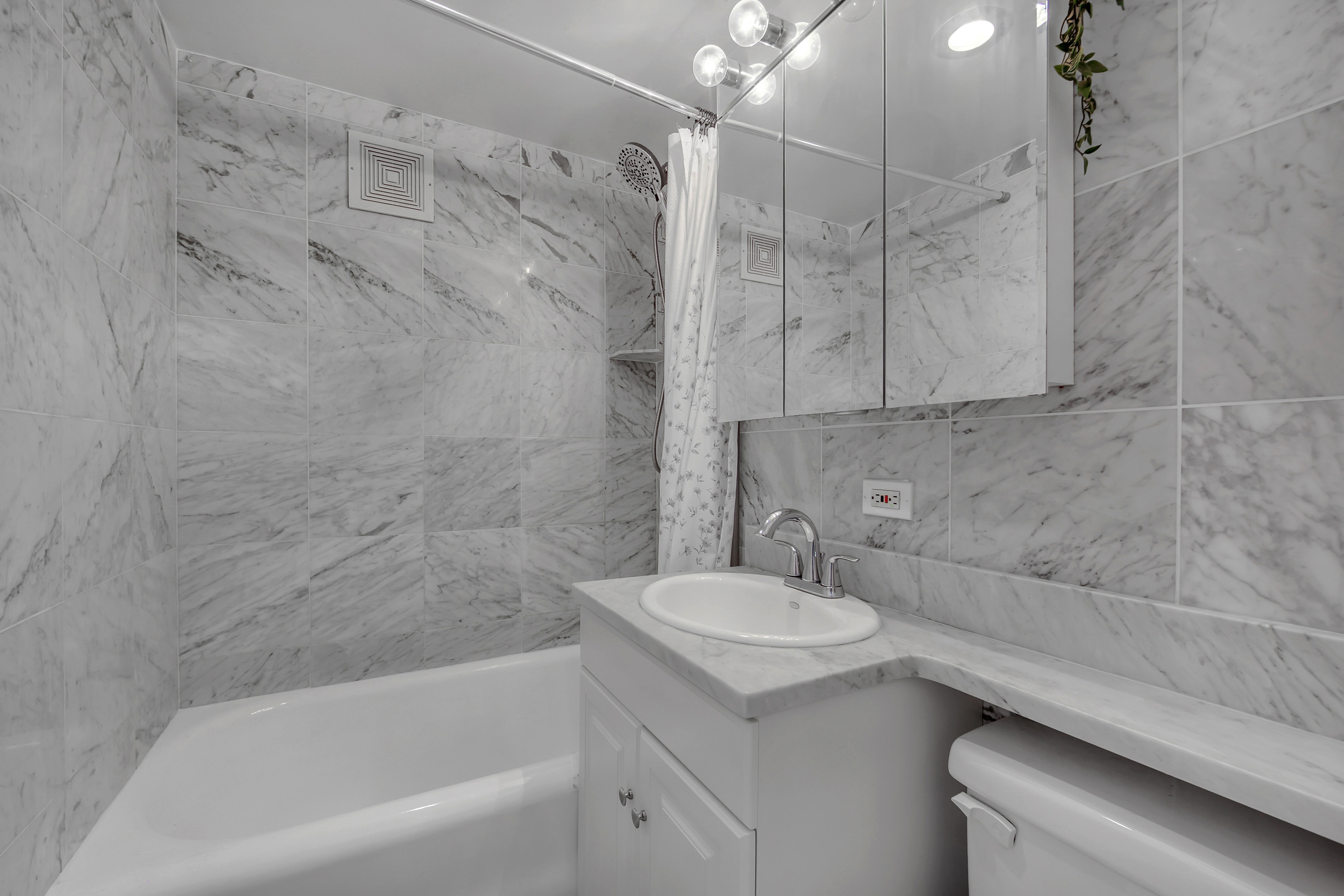 25 Tudor City Place, Unit 1707 Manhattan, NY 10017 - Photo 7 of 18 a bathroom with a sink a toilet and bathtub