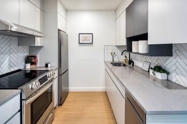 a kitchen with granite countertop a sink and a stove top oven