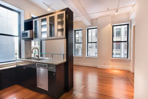 a kitchen with stainless steel appliances granite countertop a sink and wooden cabinets