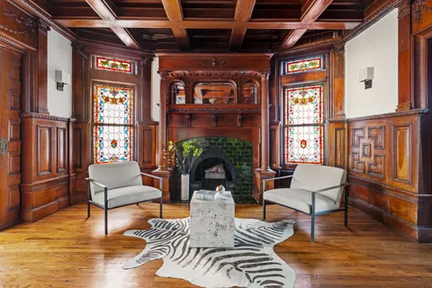 a living room with furniture a fireplace and a table