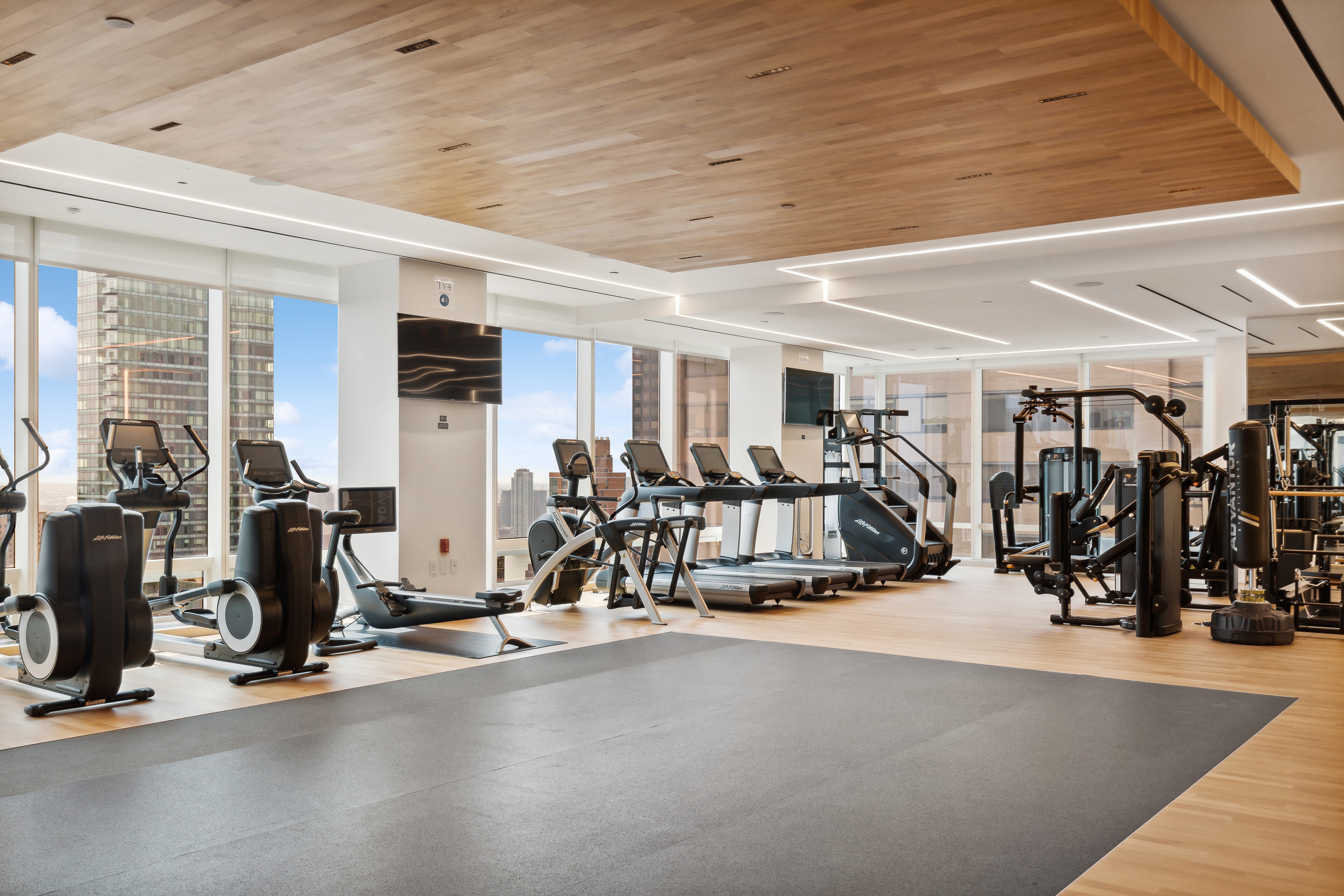 151 East 58th Street, Unit 32C Manhattan, NY 10022 - Photo 11 of 15 a view of a room with gym equipment