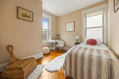 a bedroom with a bed and window