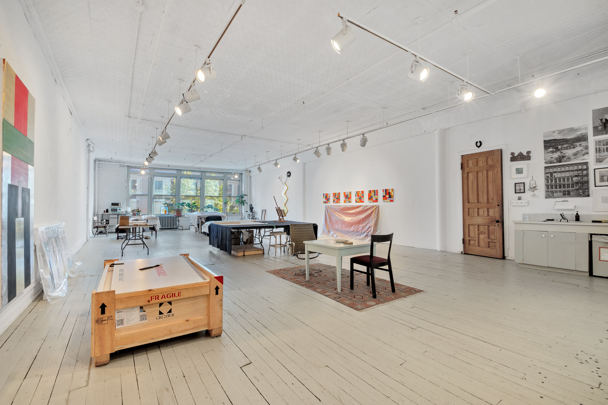 69 Wooster Street, Unit 3 Manhattan, NY 10012 - Photo 18 of 22 a living room with furniture and a wooden floor