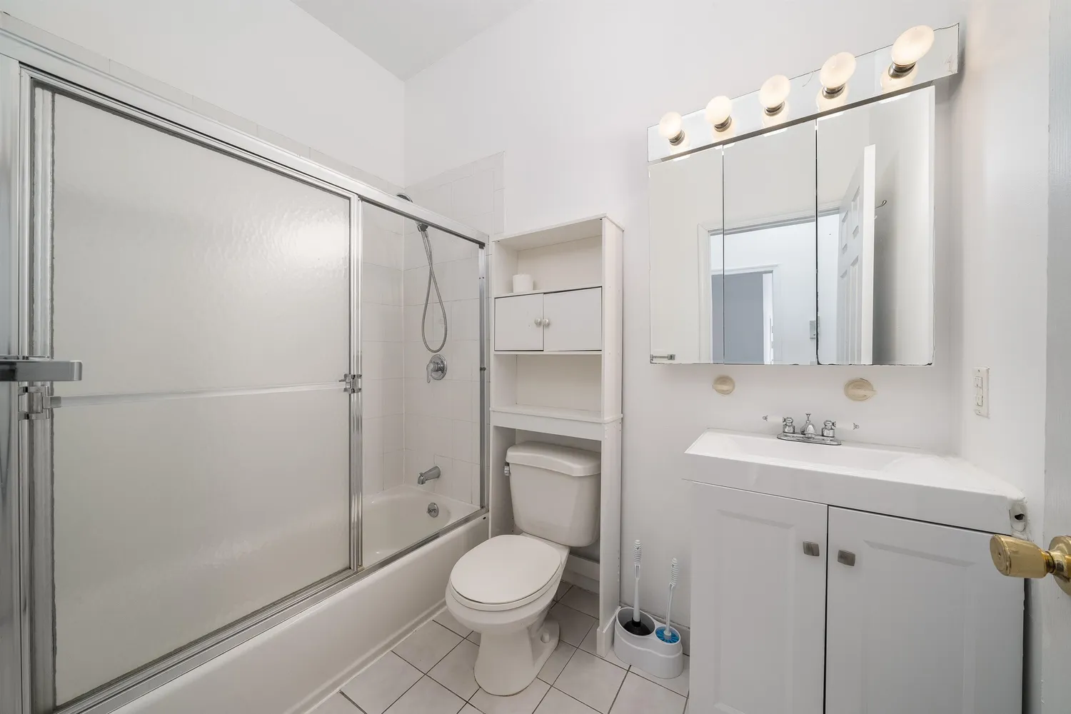 a bathroom with a toilet sink and shower