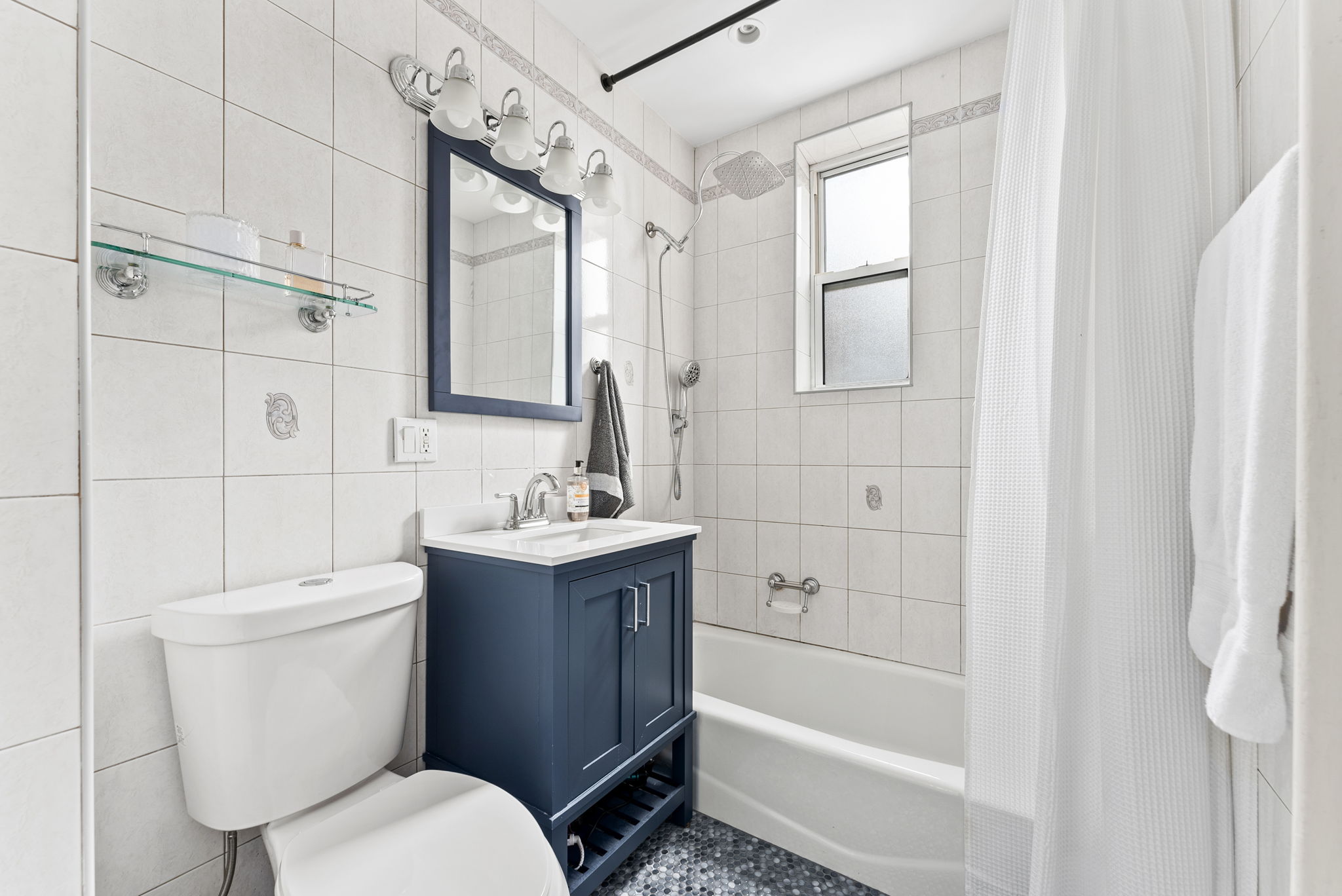 9615 Shore Road, Unit 4B Brooklyn, NY 11209 - Photo 8 of 13 a bathroom with a sink toilet and shower