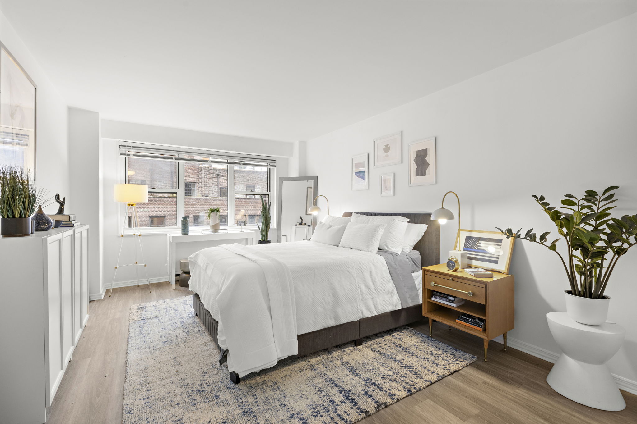 400 East 54th Street, Unit 18E Manhattan, NY 10022 - Photo 10 of 22 a bedroom with a bed and a window