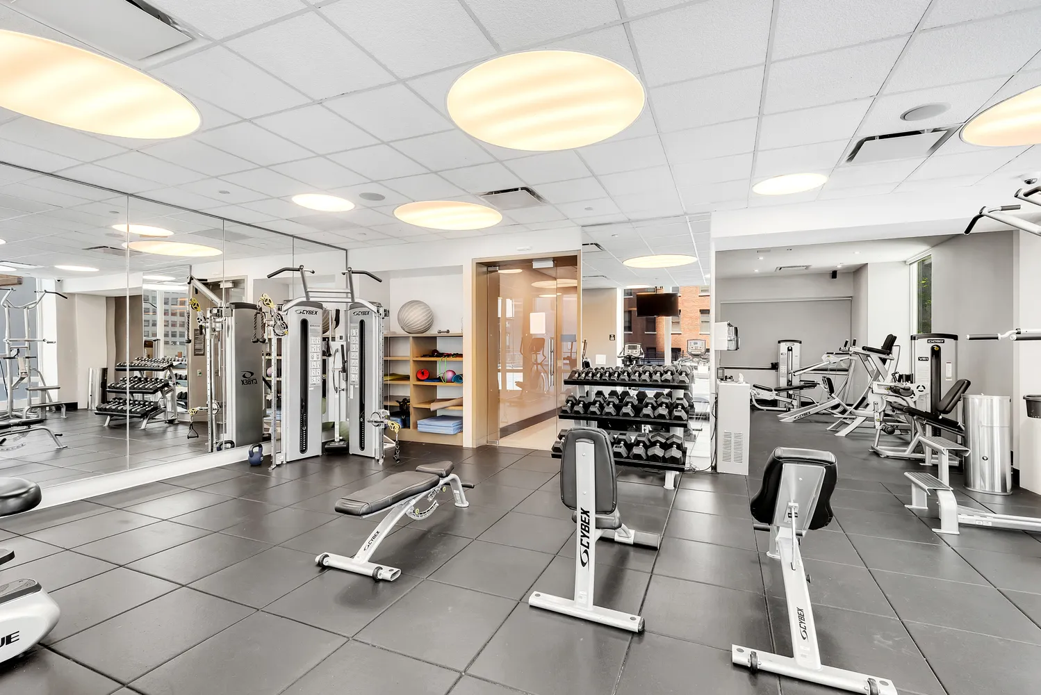 a gym room with lots of gym equipment