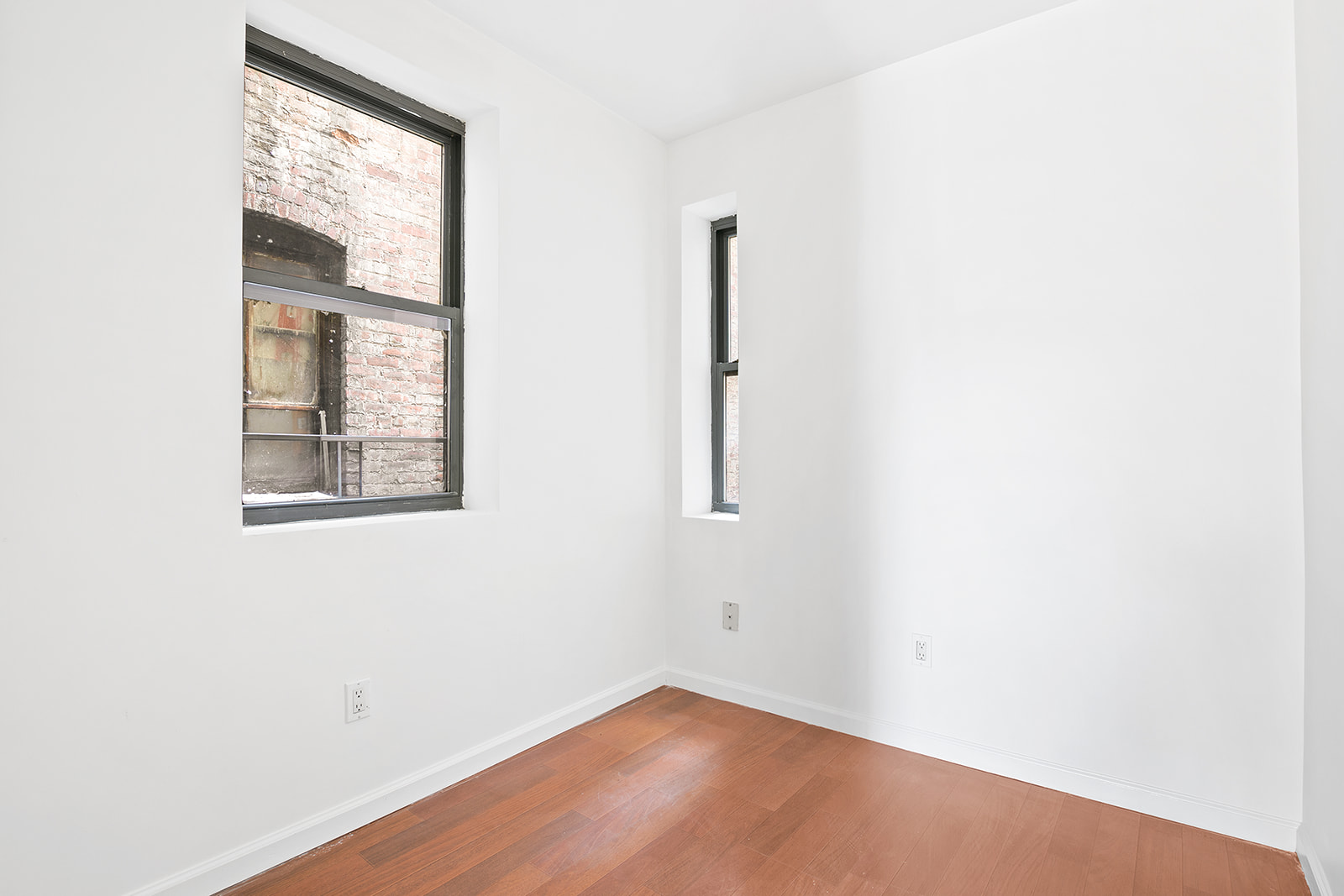 117 Henry Street, Unit 11 Manhattan, NY 10002 - Photo 3 of 4 an empty room with a window
