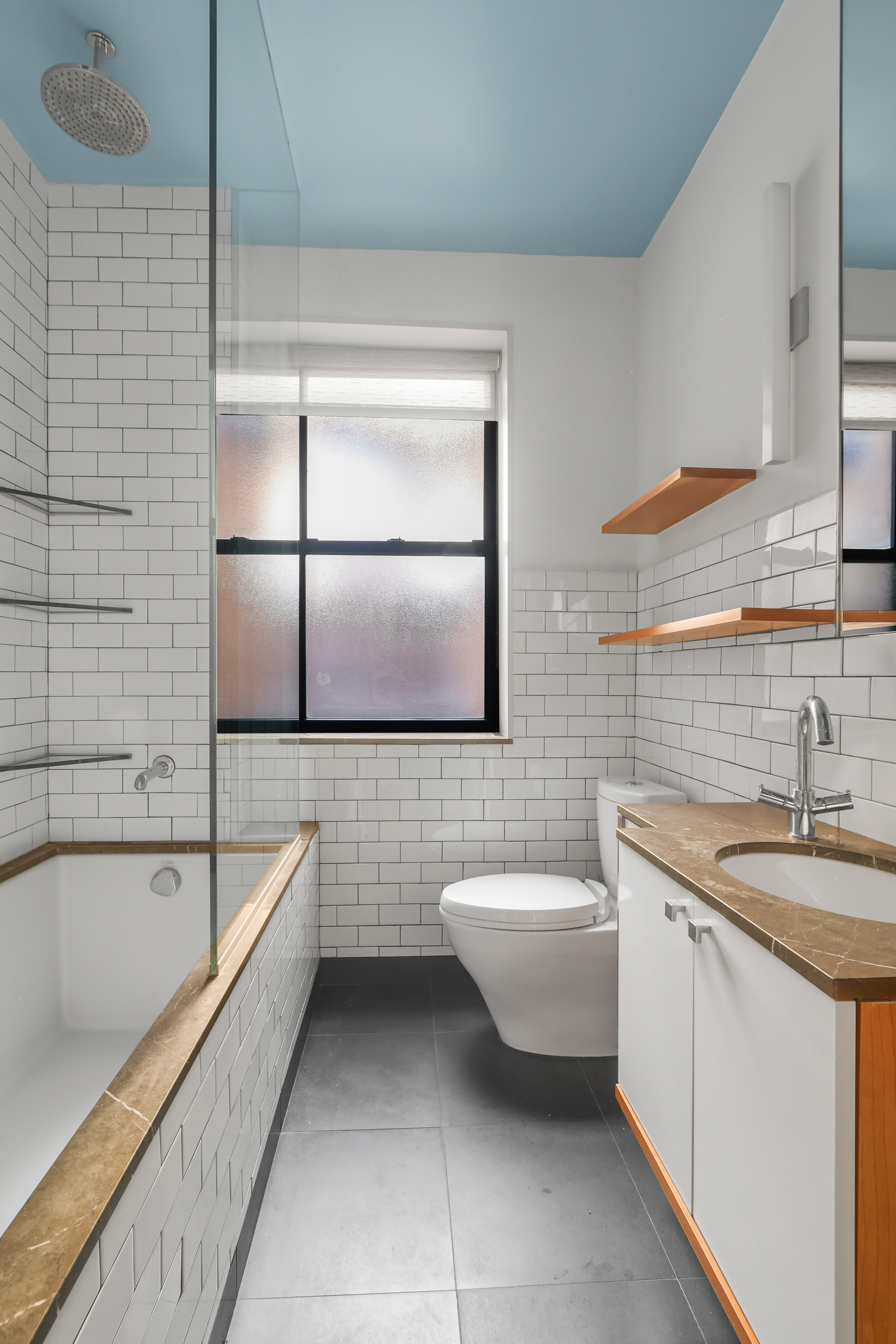 311 West 97th Street, Unit 6E Manhattan, NY 10025 - Photo 12 of 18 a bathroom with a granite countertop sink mirror and bathtub