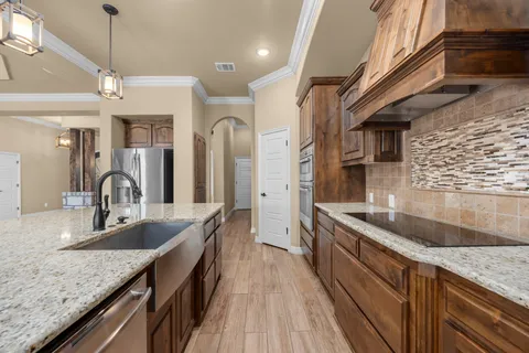 a view of a dining room with furniture wooden floor and chandelier