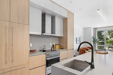 a kitchen with a sink a stove and cabinets