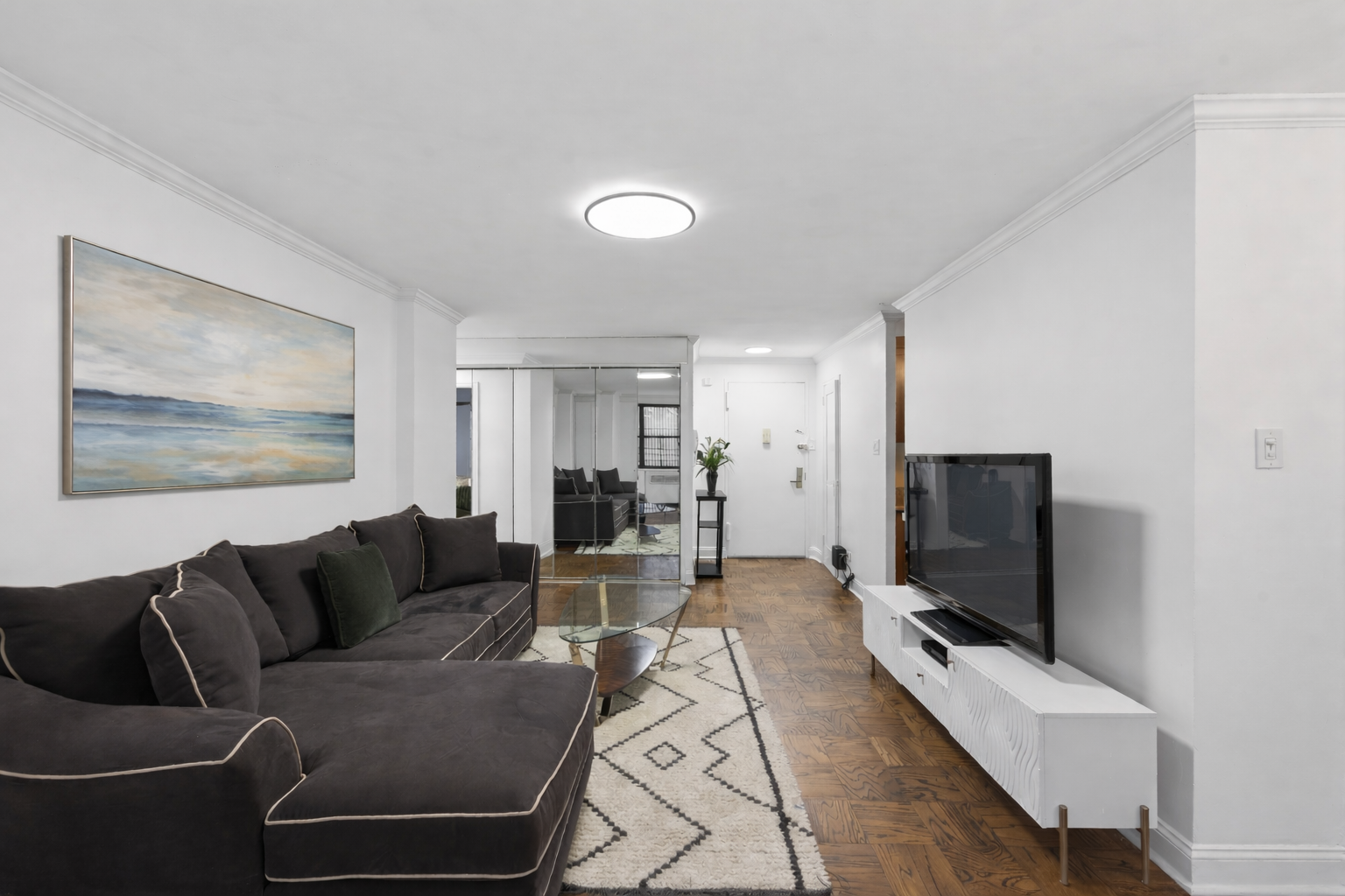330 3rd Avenue, Unit 8A Manhattan, NY 10010 - Photo 3 of 13 a living room with furniture and a flat screen tv