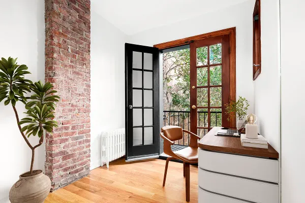 a work room with furniture and a potted plant