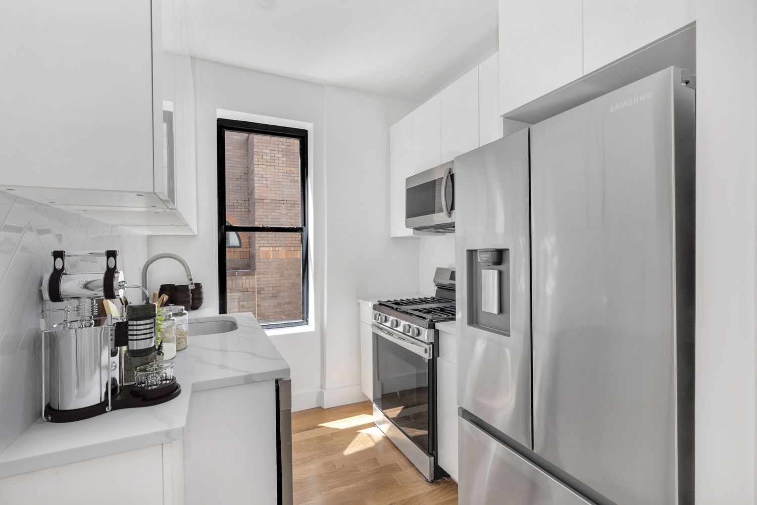 640 Ditmas Avenue, Unit 16 Brooklyn, NY 11218 - Photo 3 of 8 a kitchen with a refrigerator sink and white cabinets