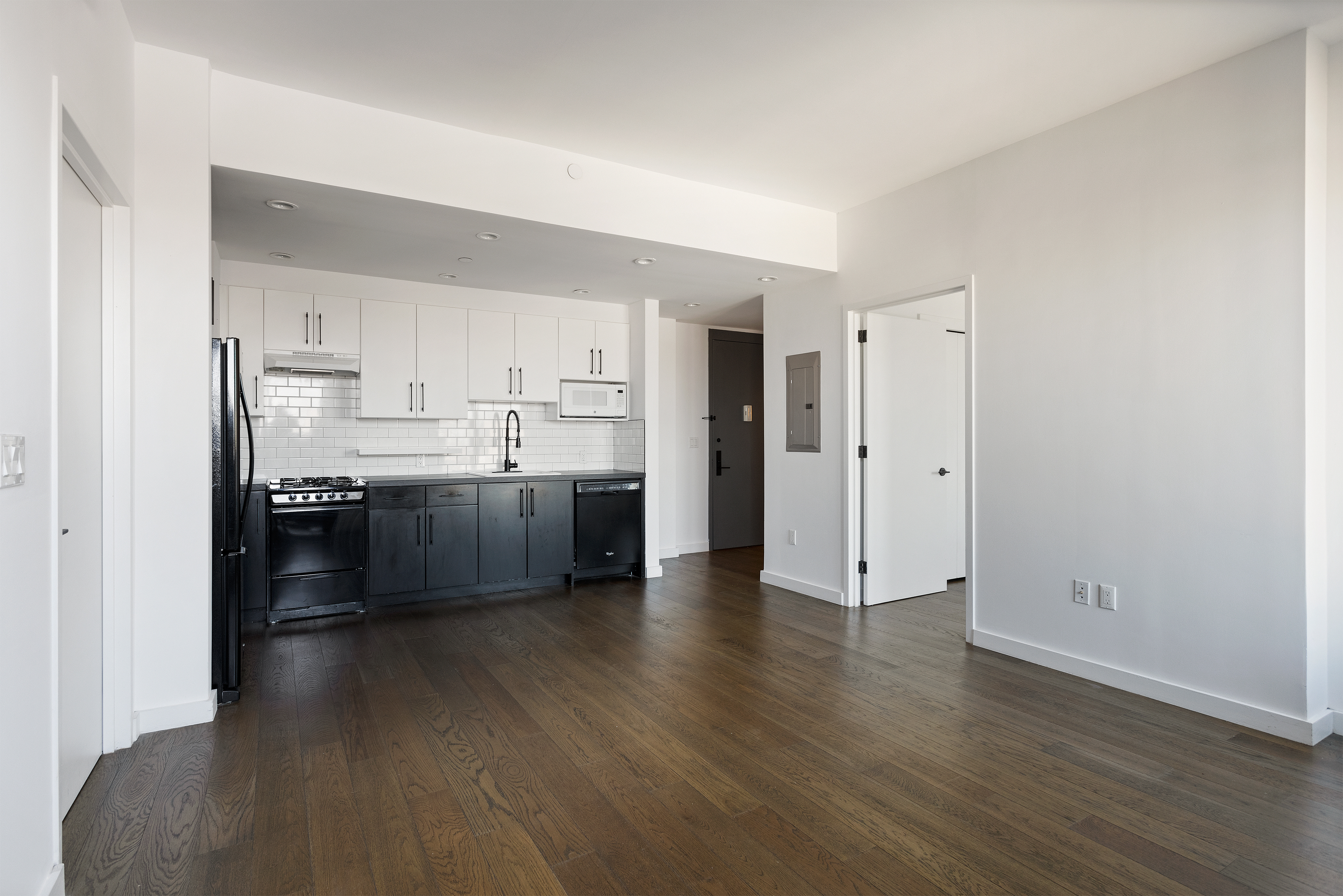 16-26 Madison Street, Unit PHA Queens, NY 11385 - Photo 3 of 16 a kitchen with stainless steel appliances a refrigerator sink and white cabinets