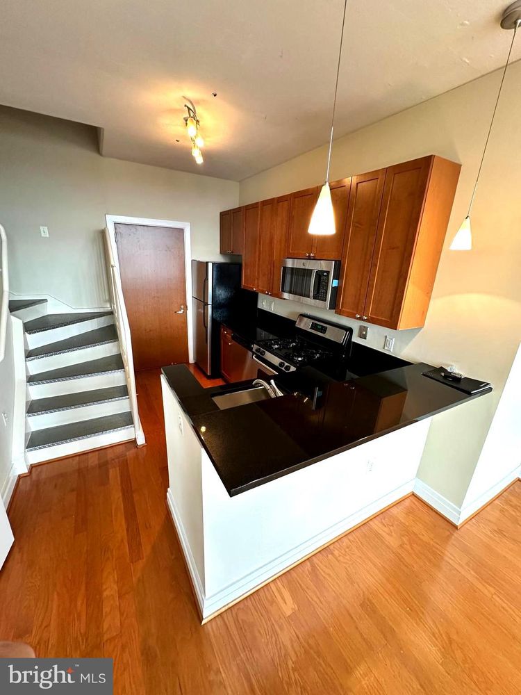 2120 Vermont Avenue Northwest, Unit 620 Washington, DC 20001 - Photo 11 of 61 a kitchen with a sink and refrigerator