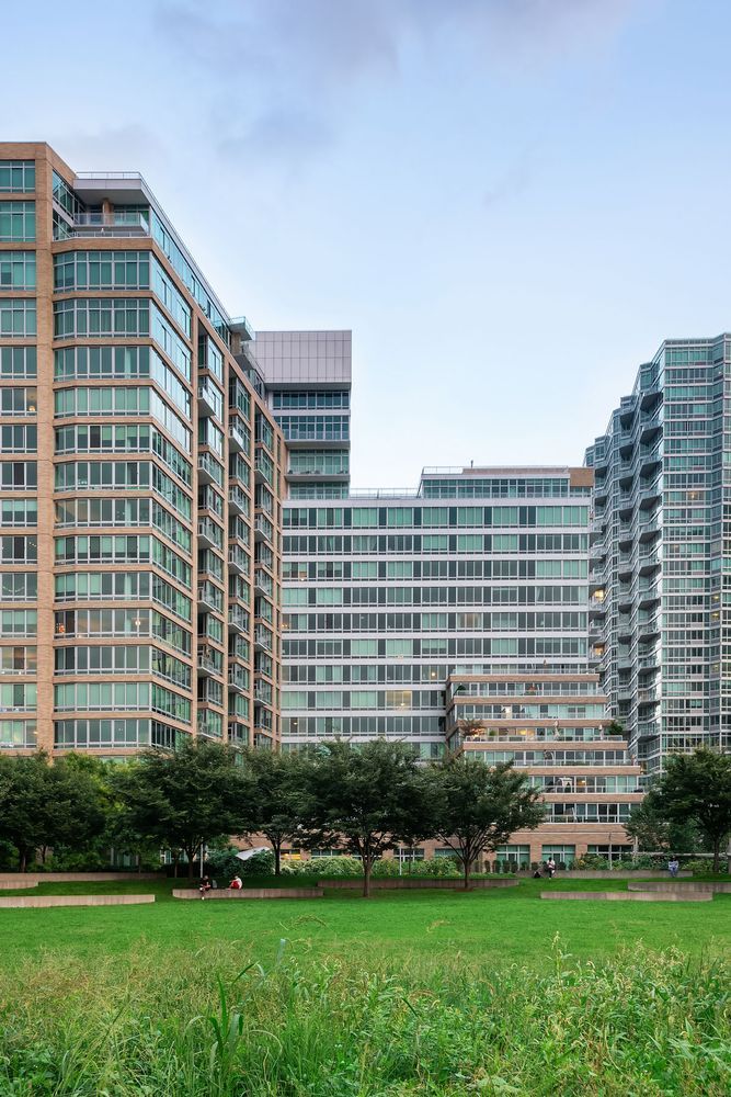 46-30 Center Boulevard, Unit 1209 Queens, NY 11109 - Photo 23 of 26 a front view of a building with a garden