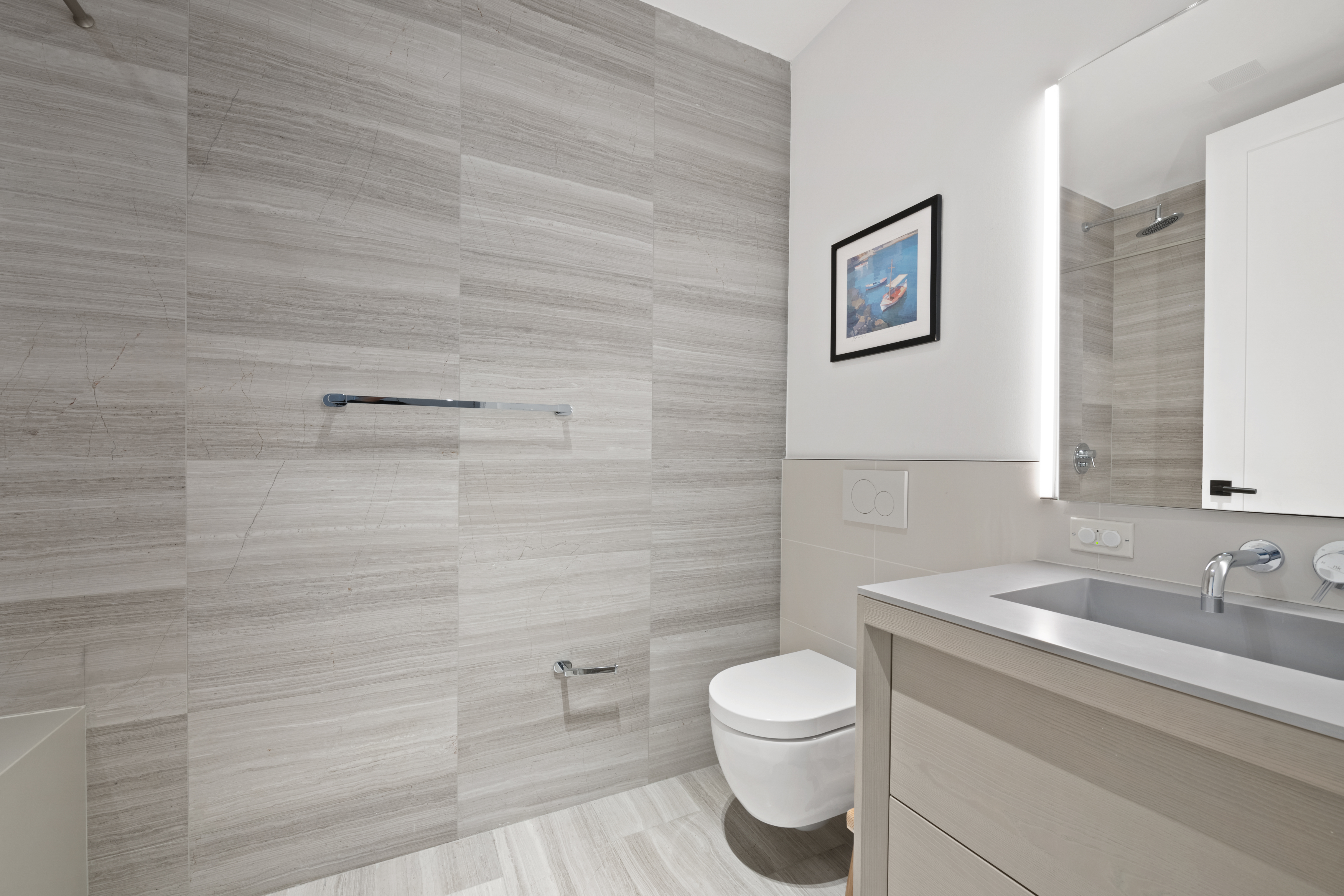 225 West 17th Street, Unit 6B Manhattan, NY 10011 - Photo 8 of 11 a bathroom with a toilet a sink and mirror