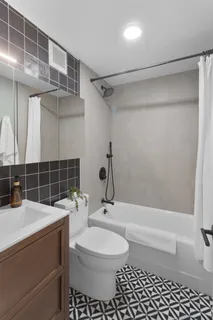 a bathroom with a sink toilet and shower