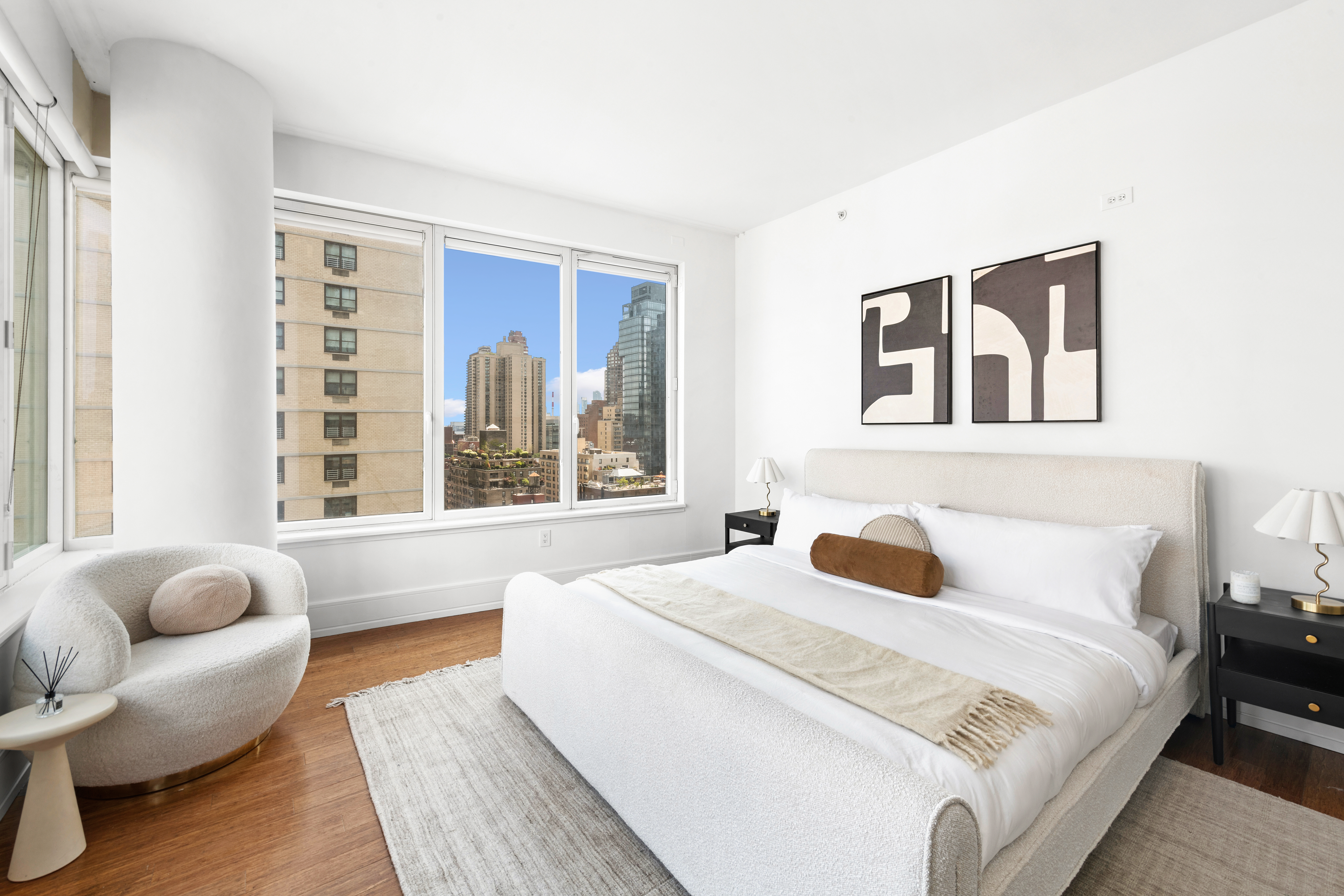 255 East 74th Street, Unit 14C Manhattan, NY 10021 - Photo 6 of 14 a bedroom with a bed and a large window