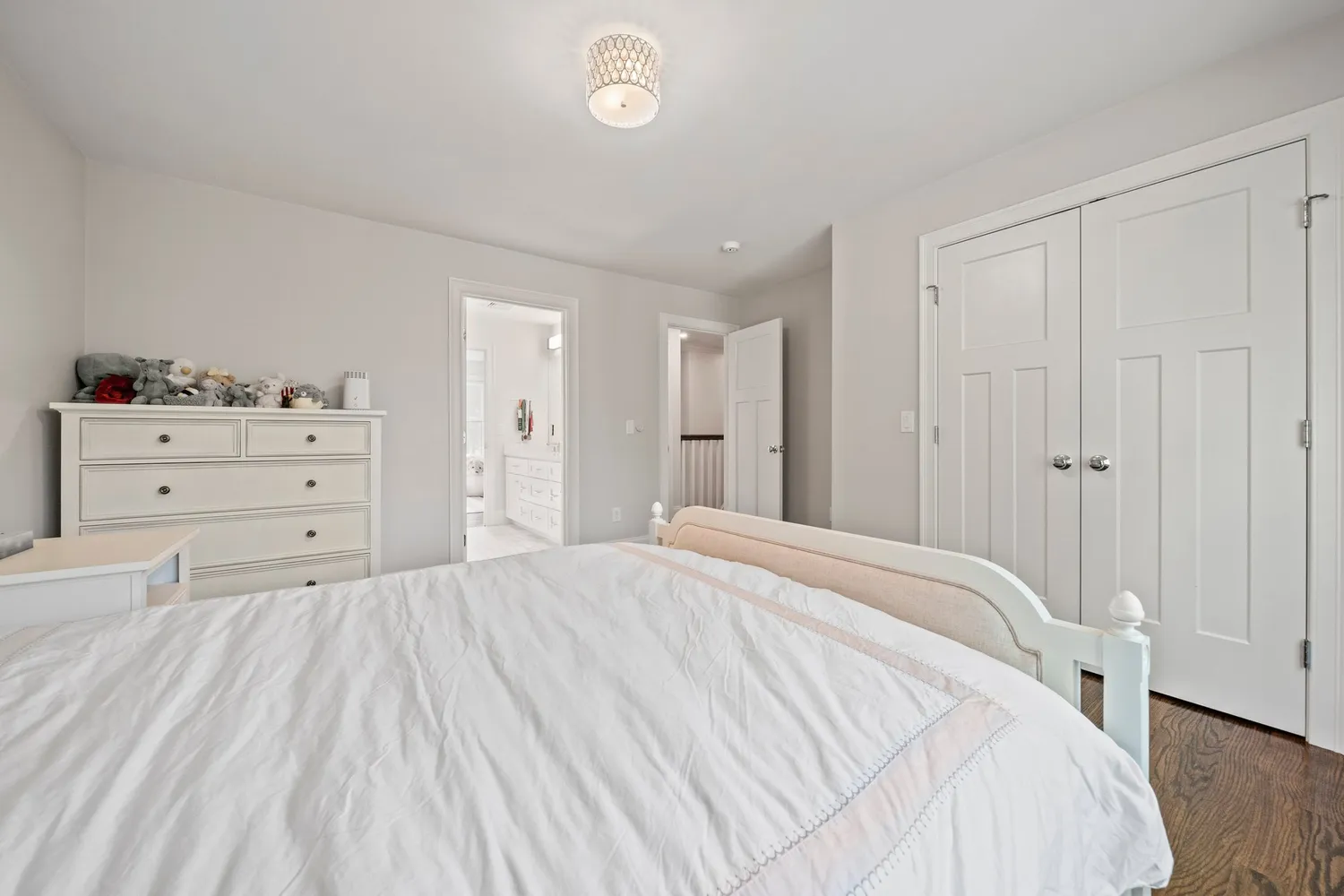 a spacious bedroom with a bed and a window