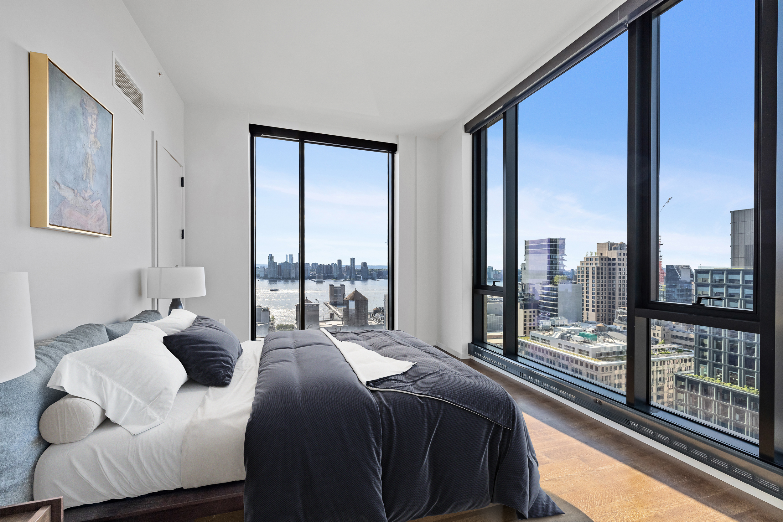 570 Broome Street, Unit 23A Manhattan, NY 10013 - Photo 7 of 13 a large bedroom with a bed and a large window