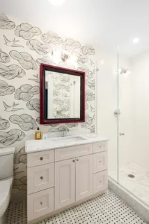 a bathroom with a sink a vanity and a mirror