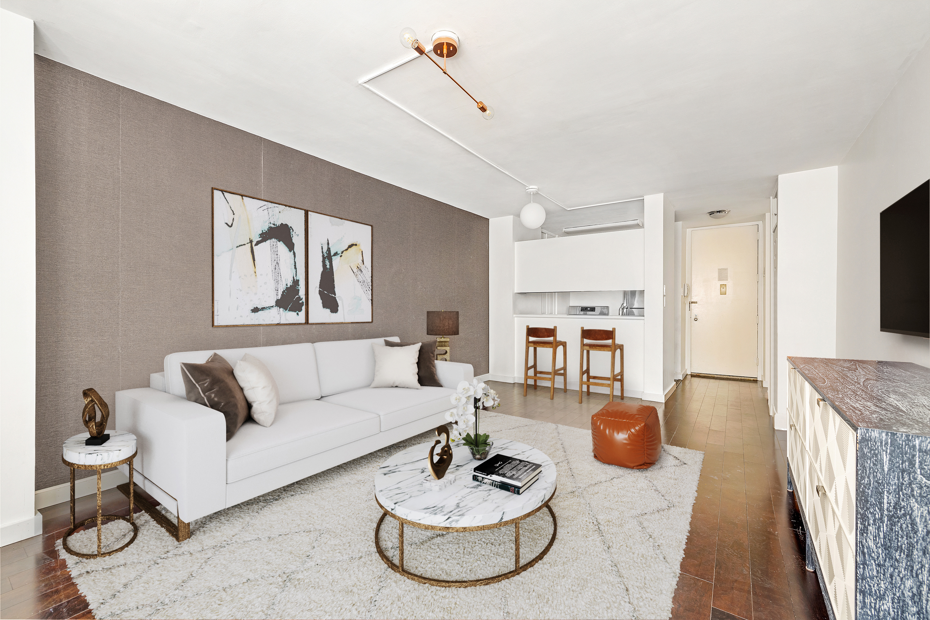 145 East 48th Street, Unit 8D Manhattan, NY 10017 - Photo 2 of 8 a living room with furniture and a dining table with kitchen view