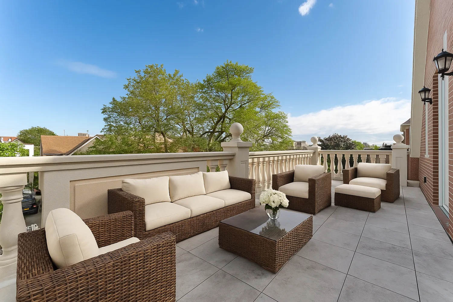 a roof deck with couches and potted plants