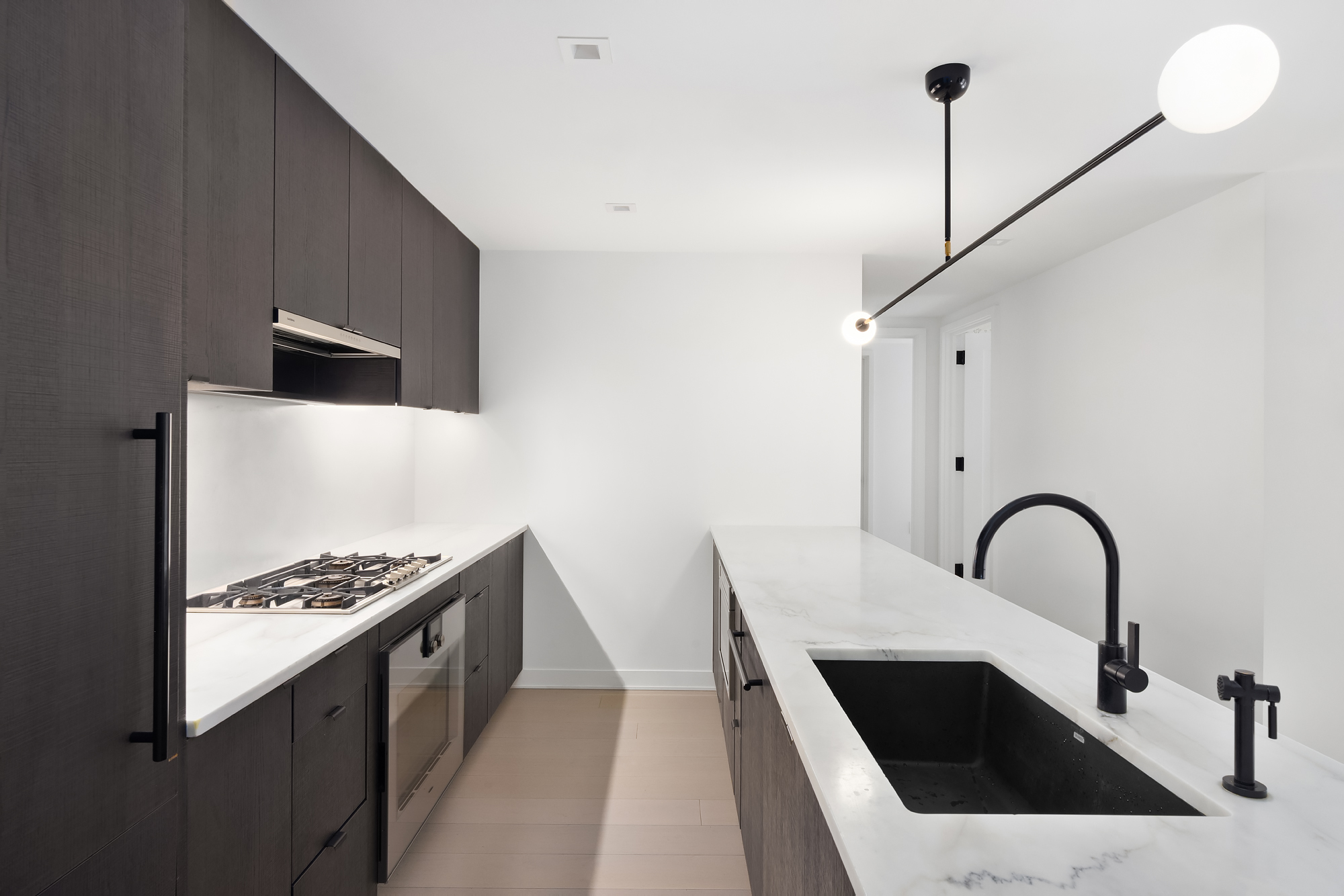 55 West 17th Street, Unit 603 Manhattan, NY 10011 - Photo 4 of 9 a kitchen with kitchen island a sink and appliances