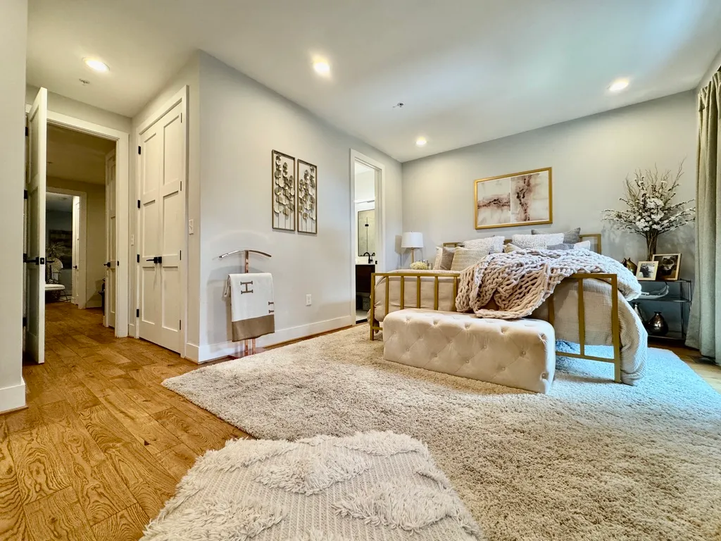 a bedroom with a large bed and a couch